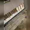 Installation in progress shows the system lining the walls to create continuous drainage.