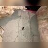 The pink fiberglass insulation be absorbing water. We pull it aside to expose the crack.