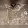 Damage concentrated around a pipe penetration shows cracking and displacement in the foundation wall. This area was structurally reinforced during the seismic retrofit to prevent future movement.