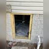 New framing is built with pressure-treated wood to ensure the seal is secure for the new crawl space door.
