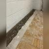 The Frontier Team jackhammers the floor to create space for the WaterGuard sub-floor drainage system.