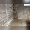 The cinder block walls of this basement show signs of moisture.