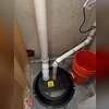 The sealed sump pit was upgraded with a new sump pump and domed cover to support proper system airflow and moisture control.