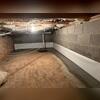 Waterguard was installed around the perimeter of the crawl space to collect any seeping water coming from the walls and floors and drain it to the sump pump. CleanSpace was installed on the lower half of the wall to keep moisture and odors from passing through.