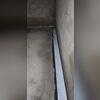 Installation in progress shows the system lining the walls to create continuous drainage.