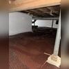 We then installed our dimpled drainage matting all over the floor of the crawl space for additional drainage. This matting will also help strengthen the CleanSpace vapor barrier over it.