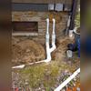 **Photo Summary: Installation of IceGuards**  
This photo captures the installation of IceGuard fittings on the exterior discharge line. These fittings are essential for preventing basement flooding caused by frozen or clogged discharge pipes, ensuring that water can safely escape even during...