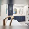 Blue cabinets and gold handles keep the room anchored and functional.