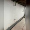 WaterGuard panels are being installed to capture incoming water before it can damage the basement.