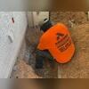 A crew member begins excavating along the home's footing to prepare for push pier installation. This step exposes the foundation so the structural brackets can be mounted securely. Ideal for homeowners in San Tan Valley experiencing settlement from expansive soil conditions.