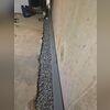 We installed our WaterGuard Drainage System by first excavating a shallow trench along the interior perimeter of the basement floor. Once the trench was prepared, the WaterGuard piping was placed on top of the footing to ensure proper drainage without clogging. The system was then connected to the...