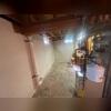 This early photo shows the basement before repairs began. Water intrusion along the cove joint and visible wear on the floor indicated the need for a full waterproofing system and wall reinforcement.
