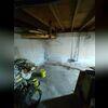 Water intrusion through the foundation wall led to pooling on the basement floor. Persistent leaks rendered the space unsuitable for storage and created conditions conducive to mold growth and wood rot due to elevated humidity levels.