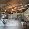PowerBraces installed along the cinderblock foundation wall to stabilize severe inward bowing.