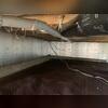 This photo shows the first steps we took to start the encapsulation. We laid down our dimpled drainage matting all over the floor to protect the vapor barrier we installed over the top of it later in the process. This photo also shows our SilverGlo insulation panels installed along the walls.