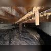 This crawl space was a mess of old vapor barrier, debris, and exposed wet earth