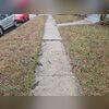 This sidewalk had multiple areas of unevenness and sunken slabs, creating trip hazards.