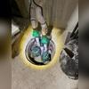 The previously installed sump pump was not effectively capturing or managing the groundwater seepage occurring within the home, resulting in continued moisture intrusion.