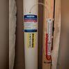 System manometer mounted on the pipe to monitor proper suction and confirm the radon mitigation system is operating effectively.