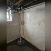 The sump pump works with the interior drainage system to keep water moving out of the basement.