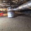 The crawl space before the project was damp and insecure.