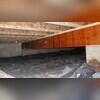 Before the project started, the crawl space had an improperly installed and failing vapor barrier that left large areas of the ground exposed to moisture. This inadequate protection allowed humidity to build up, leading to visible mold growth on the wood surfaces and contributing to musty odors...
