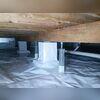 In this photo, you can see the two SmartJack posts we installed on both sides of the middle column, right under the main beam. These posts helped level out the floor joists above.