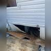 The crawl space entrance was covered by a loose plank of wood, allowing rainwater to flow directly into the crawl space.