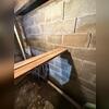 The presence of stairstep and vertical cracking was a clear indicator of foundation wall instability. As the concrete block wall continued to separate, immediate structural stabilization was required to prevent further movement and damage.