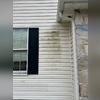 The siding was covered in black and green staining, leaving it looking discolored and dingy.