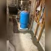 The TrenchDrain&reg; surface drainage system was strategically installed around immovable basement utilities to intercept surface water and convey it efficiently to the sump pump system.