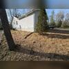 Here you can see the home after being stabilized by Fortress Foundation Solutions. We backed filled the hole and covered with straw and grass seed.