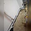 The WaterGuard system is carefully laid in place along the trench, ready to channel water away from the basement.