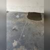 One cause of cracked concrete is shrinkage, a change in the concrete's volume over time. As the volume of concrete decreases and the surface cannot move freely, tensile stress occurs, resulting in cracks.