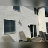 This home needed new windows and siding due to rotting wood beneath the stucco.