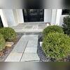 The entryway also got an upgrade with a new portico and metal pent roof, paver walkway, and a blue stone stoop.