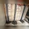 The crew re-concretes the floor around the I-beams.