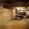 This photo was taken by our inspector upon the initial visit. This wall on the left hand side had a large horizontal crack running through it.