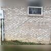 When settlement occurs, most homes begin to crack at the windows, as they are the weakest part of the structure. You can see how the base of the window slopes right along with the slope of the grade the home rests on.