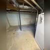 This Lexington, NC basement shows visible stair-step cracking along the block foundation wall an early sign of foundation movement and water intrusion. Moisture stains along the floor and wall indicate ongoing water seepage, which can lead to structural issues and unhealthy humidity levels if left...
