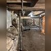 The existing basement support columns were inadequately sized and improperly supporting the imposed loads from the floors above, resulting in excessive deflection that manifested as floor bounce, audible creaking, and noticeable sloping.