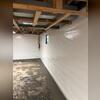 WaterGuard drains were installed around the perimeter of the basement, right underneath the floor slab. The vapor barrier was tucked into the subfloor drainage system to help channel moisture away from the walls.