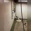 This sump pump works quietly beneath the basement floor, efficiently directing water away from the home. Fully installed, it's a crucial component in preventing water damage.