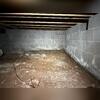 The foundation water shows that water was standing in the crawl space at one time, leaving a line of moisture on the wall. Efflorescence above that line shows where water seeped through the blocks and evaporated into the space.