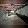 Standing moisture and debris highlight why encapsulation is needed for this space.