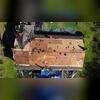 The crew tears off the layers of old shingles and underlayment to inspect the decking