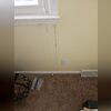 A large crack going from the window frame to the floor was indicating signs of foundation settlement.