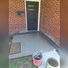 Woods installed a TrenchDrain Grated Drain Pipe to accept and redirect water from the doorway.