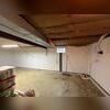 This photo shows where we installed our sump pump system. It also displays what our drainage system looks like around the perimeter of the basement before we conceal it with concrete. The window well drain ties right into the subfloor system.