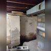 Here you can clearly see that water was making its way through these concrete block walls because there are stains all over the walls and the concrete on the column has totally deteriorated. 
Also, a trench has been dug out to prepare for the installation of the interior drainage system.
